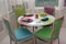 Round table with colorful bright chairs