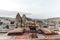 round table, pillows and traditional carpet on terrace and beautiful scenic of buildings and rocks