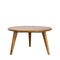 Round table with wooden legs on a white background