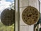 Round thermometer reflected in window on a summer day.