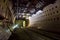 Round tiled tunnel in abandoned underground nuclear physics laboratory