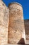 Round tower or turret in defensive walls of Niebla castle, with the flag of Spain, in Huelva, Andalucia, Spain