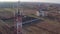 Round view of cellphone tower near village, maintenance worker servicing cellular antenna