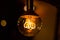 Round vintage lightbulb with glowing wire