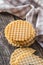 Round waffle biscuits on wooden table