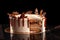 Round white cake with caramel and chocolate puffed rice on a round tray on black background