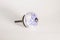 Round white drawer pull or knob with a blue  flower design