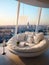 Round white sofa in penthouse with city view. Interior design of modern living room