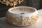round white wash basin with elaborate gold accents and delicate designs