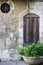 Round Window with openwork wrought iron lattice and window with iron shutters