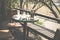 round wood table on terrace of house. wicker rattan chair on pat