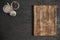 Round wooden cutting board on black table. Top view of empty kitchen trendy rustic wooden tray.