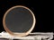 Round wooden sieve on a black background, outdated kitchen utensils