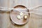 Round wooden tray and twigs, white beautiful flowers and candle