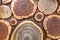 Round wooden unpainted solid natural ecological soft colored brown and yellow crackled stumps background, tree cut sections with