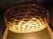 Round woven basket exposed to light