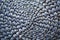 Round woven mat texture background in silver blue