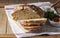 Round yeast bread made from white and whole grain flour, tomato salad and pate on a wooden background. Rustic style.