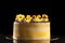 Round yellow birthday cake. Decorative cream decorations on the cake. Black background.