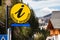 Round yellow sign and arrow Tourist information in German language