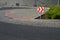 Roundabout of gray granite cubes closer to the center. beveled concrete curbs with flowers and grass in the middle of the circle.