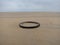 Roundabout: old tire laying on the beach