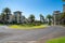 Roundabout and palm tree lined residential roads in modern seaside suburb and homes in Melbourne