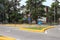 Roundabout with yellow curb and green grass in summer