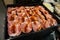 Rounded beef meat on a tray, topped with a kind of salt.