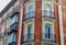 Rounded corner with elegant windows and balconies on classical building in Chueca district downtown Madrid, Spain. Classy Spanish
