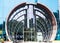 Rounded glazed entrance with rotating door in modern skyscraper, close up