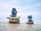 Rounded pebbles stack in peaceful evening with smooth ocean