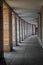 Rounded tunnel with gray stone columns and paving stone floor