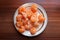 Rounded white plate with lot of orange peeled mandarin tangerine citrus