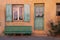 Roussillon, France: detail of a house facade with ochre colored wall and green windows