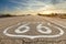 Route 66 road sign with blue sky background. Classic concept for travel and adventure in a vintage way