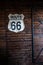 Route 66 wooden plank on wooden wall, interior vertical capture.