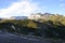 Route under the shadows, snowy mountains and background sky.