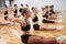 Daily routine. Group of female kids practicing athletic exercises together indoors