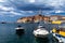 Rovinj town with multicolored buildings and yachts moored along embankment, Croatia.