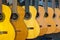 Row of acoustic guitars different color in a music instruments shop