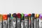 Row of artist paintbrushes with colorful bristle closeup