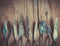 Row of artist palette knifes on old wooden rustic backdrop.