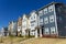 A row of attached residential suburban townhomes