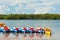 Row of beached kayaks waiting to be rented