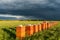 Row of Beehives Outdoor near Rapeseed or Canola Plantation. Beekeeping and Honey Productiom