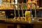 Row of beer taps in a pub with a tankard of beer