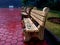 Row of benches during the rainy day in the park made of wood and stones.