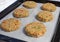 Row of best fish cakes raw uncooked on  baking tray