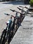 A row of bicycles leaning against a wall